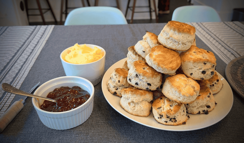 Scones on a dish with jam and clotted cream